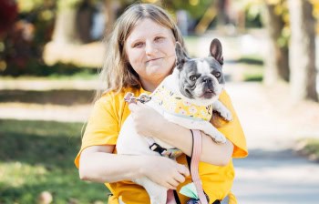 Dog Walking Team Member Holding Dog Walking & Dog Training in Oakland County (1)